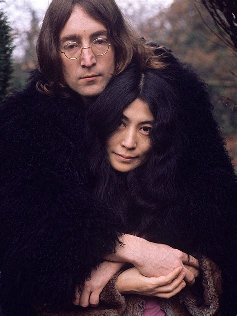 The Man And Woman Are Dressed In Black Furs Posing For A Photo With