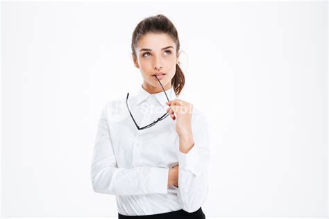 Thoughtful Young Business Woman Holding Glasses And Thinking Over White