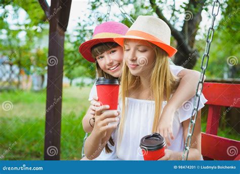 Joyful Girlfriends Having Fun On Swing Outdoor Friendship Concept Stock Image Image Of Beauty