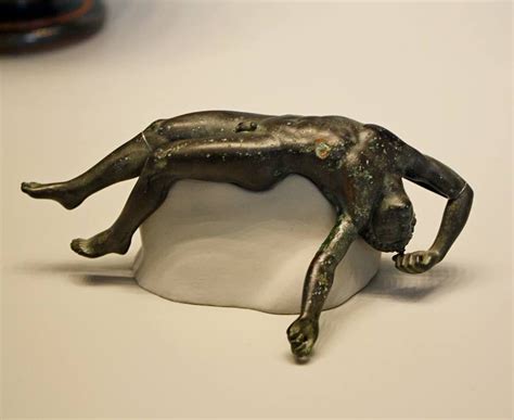 An Early Classical Greek Bronze Statuette of a Fallen Youth, Perhaps a