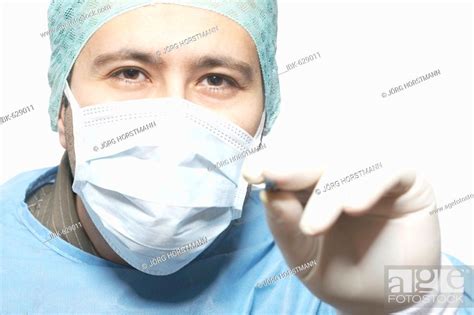 Surgeon Holding Scalpel Ready To Make The First Incision Stock Photo