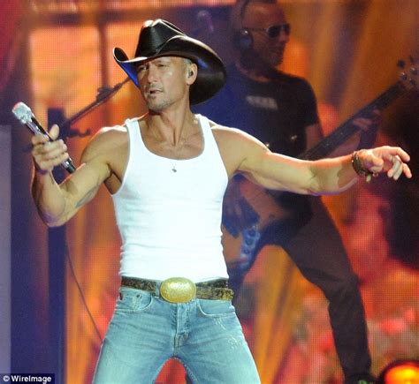 they came out of nowhere country music star tim mcgraw reveals his bulging biceps as he takes