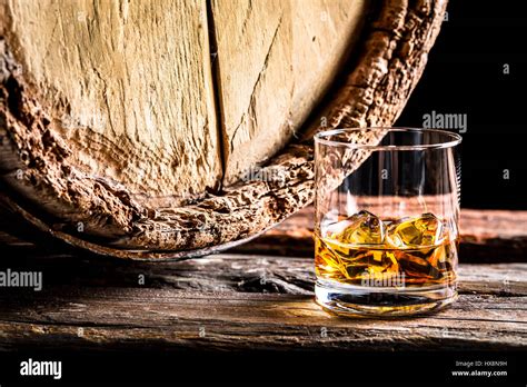 Whiskey Glass And Old Oak Barrel On Black Background Stock Photo Alamy