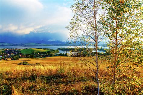 Beautiful Landscape Green And Yellow Meadow And Lake With Mountain In