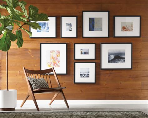 Gray carpet and white wall with room for text, black and white. Meet American Frame - Room & Board
