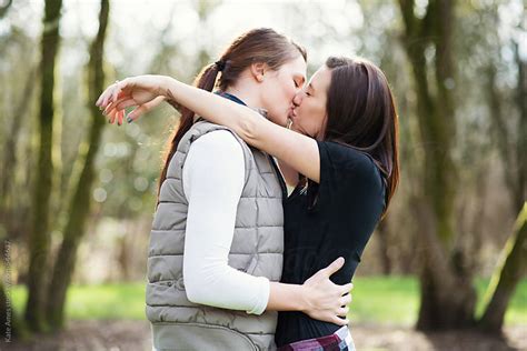 Attractive Young Lesbian Couple Kiss In The Park By Kate Daigneault Stocksy United