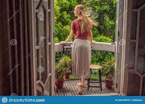 A Ginger Haired Woman Stands On A Heritage Style Balcony Enjoying Her