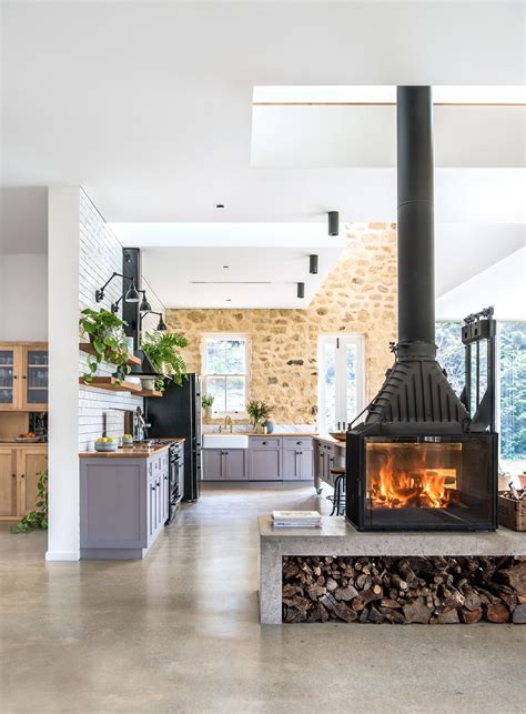 A Double Sided Fireplace Warms The Living And Kitchen Areas In This