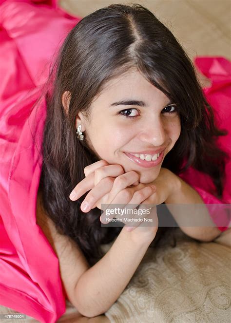 A Dark Haired Teenager Girl Rests Her Chin On Her Hands While News