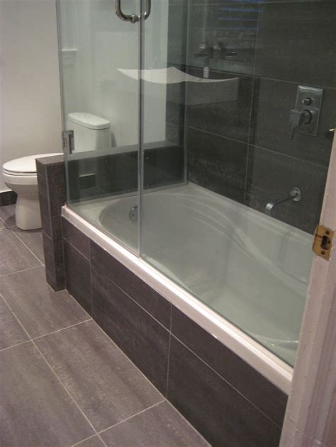 It's an efficient use of space because the clearance area for the bath is used as the shower. White Wall Compact Bathroom Modern Designs With Black Tile ...