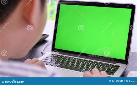 Over The Shoulder Shot Of Asian Boy Looking At Green Screen Stock