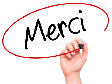 Équipez La Main écrivant Merci Merci En Français Avec Le Marqueur