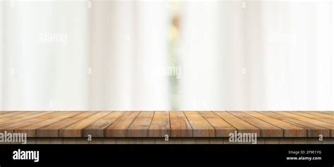 Empty Wood Table Top On Blur White Window Background For Product Or
