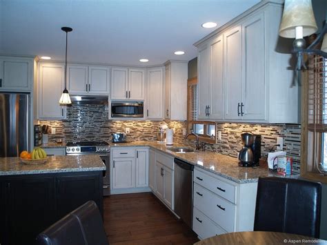You can get some inspiration to decorate your kitchen by choosing the one that matches your style. White Kitchen Cabinets, black island, nice back splash ...