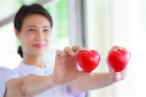 Red Heart Held By Male And Female S Both Hands Represent Helping Hands