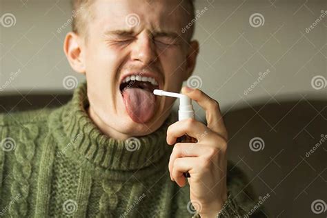 Sick Caucasian Young Man With Open Mouth And Long Tongue Using A Throat