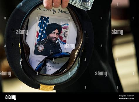A Houston Police Officer Places A Picture Of Harris County Sheriffs
