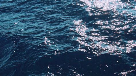 Slow Mo of beautiful sunlit blue deep sea waves. Real ...