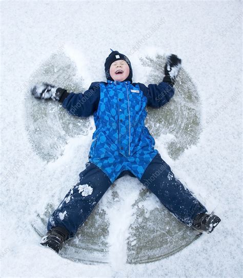 Child Lying In The Snow Creating Snow Angel Norway Stock Image