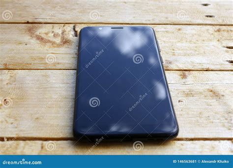 Reflection Of Blue Sky With White Clouds On The Smartphone Screen On A