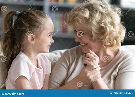 Overjoyed Mature Grandmother Have Fun Talking With Little Granddaughter Stock Image Image Of