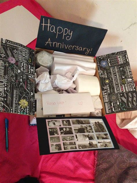 an open box with pictures and writing on it, sitting on a pink cloth
