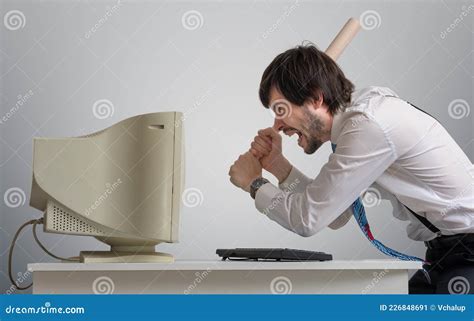 Angry Man Is Destroying Old Computer With Baseball Bat In Office Stock