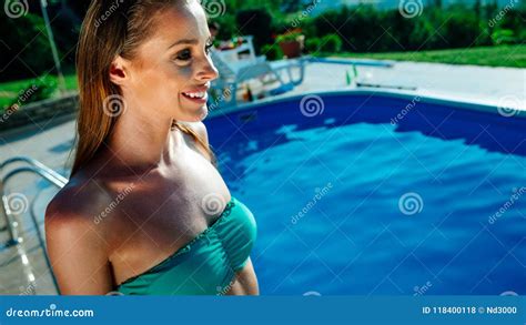 Woman Relaxing And Sun Tanning By The Swimming Pool Stock Photo Image