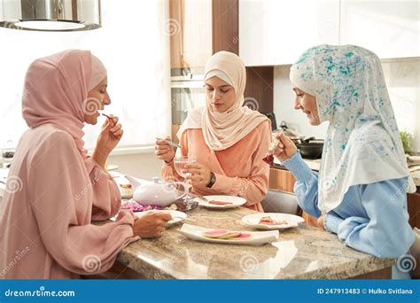 Muslim Women Having Dinner Together In Kitchen Stock Image Image Of