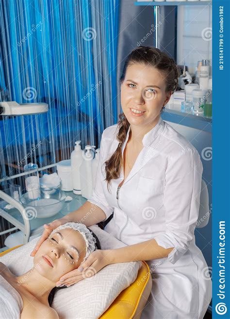 Professional Beautician Makes A Facial Massage To A Woman Stock Image
