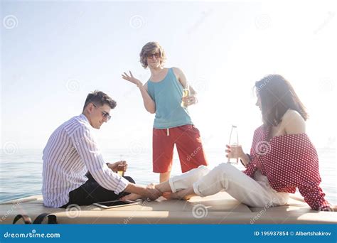 Yacht Drinking Beers While Talking Group Of Friends Having Party On