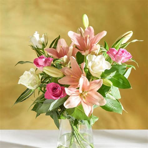 Say Hello In Style With This Postal Rose And Lily Bouquet With Chocs