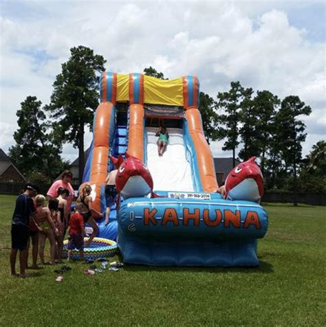 An Inflatable Slide With People Standing Around It