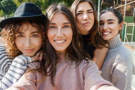 Smiling Girlfriends Taking Selfie By Stocksy Contributor Guille