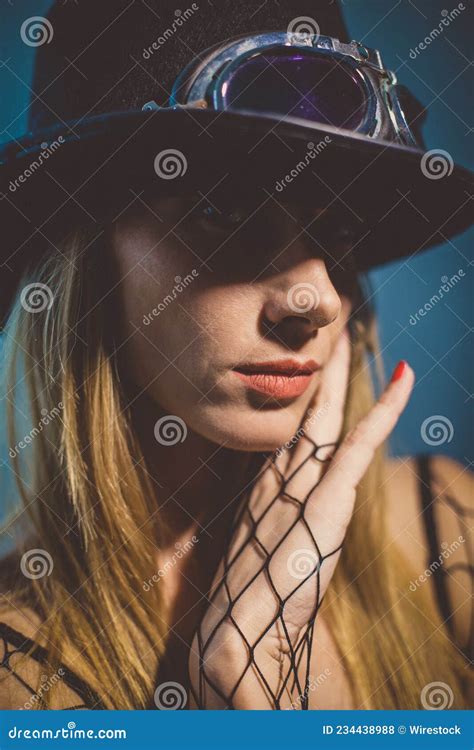 Portrait Of A Beautiful Blonde Woman Wearing A Fedora Hat And Fishnet