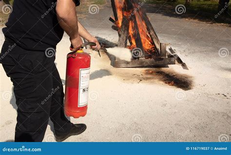 Young Man Pointing A Powder Type Fire Extinguisher Forwards Stock Image
