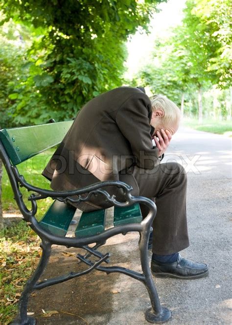A Sad Elderly Man Sitting On A Park Stock Image Colourbox