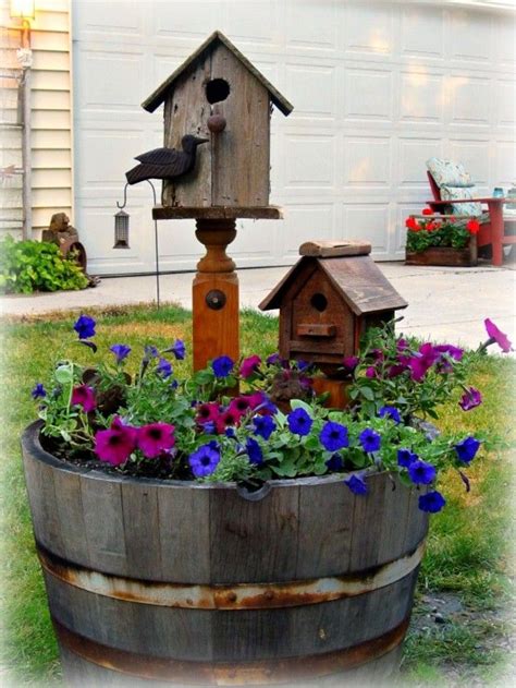 A Whiskey Barrel Planter Love The Idea Of Having The Bird Feeders In