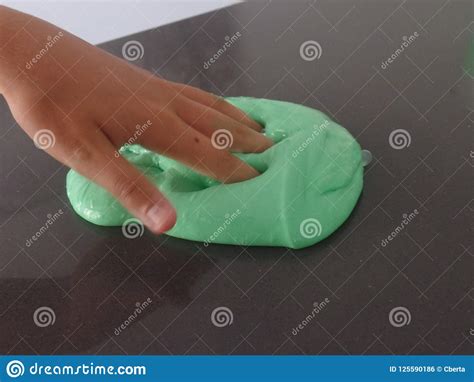 Child S Hand Poking Bright Green Slime Stock Photo Image Of Bright