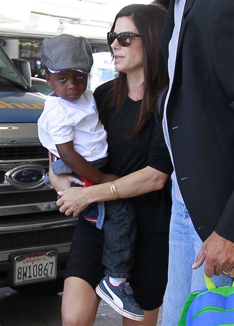 Sandra Bullock Holds Her Son Louis At Lax Popsugar Celebrity