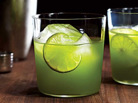Two Glasses Filled With Limeade On Top Of A Wooden Table