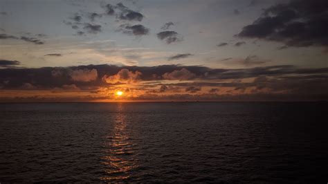 Download Wallpaper 3840x2160 Sea Horizon Clouds Sun Sunset Dark 4k