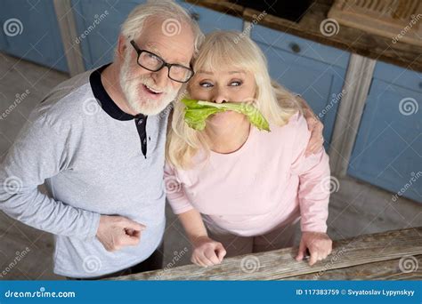 Elderly Couple Having Fun In Kitchen Stock Image Image Of Portrait