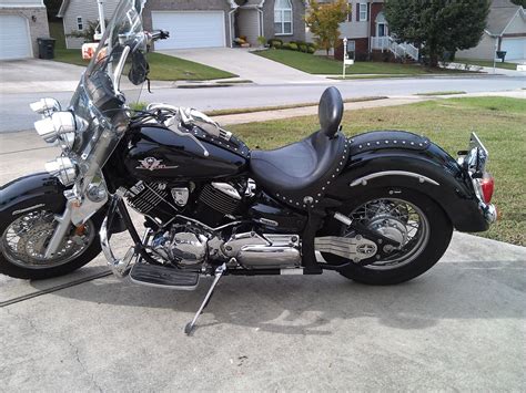 A Black Motorcycle Parked In Front Of A House