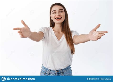 Smiling Friendly Female Host Stretch Out Hands And Inviting Reaching