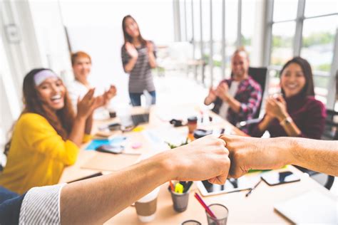 Business Partners Or Coworkers Fist Bump In Team Meeting Multiethnic Diverse Group Of Happy