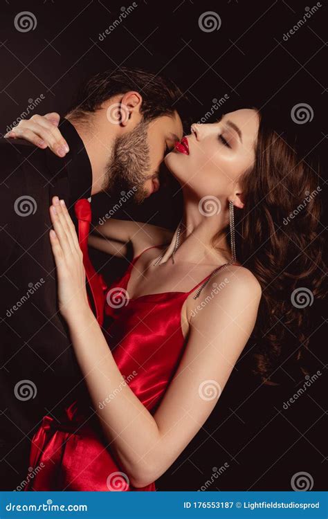Side View Of Man In Suit Kissing Attractive Woman In Red Dress Stock Image Image Of Black