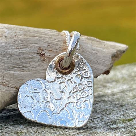 Buried in the earth's crust, silver has been recognized around the world as a precious and valuable metal. Handmade sterling silver textured heart pendant necklace ...