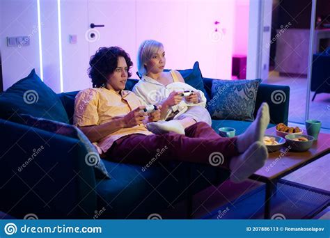 Happy Boyfriend And Girlfriend Playing Video Games And Holding