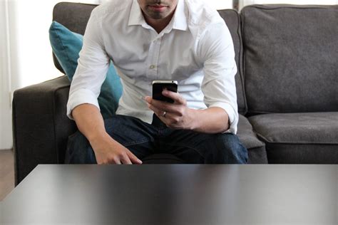 Free Stock Photo Of Man Sitting On Couch Using Phone